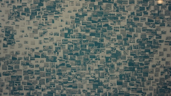 A collage consisting of numerous small rectangular images arranged closely together, creating a mosaic effect. The images seem to depict various scenes and subjects in monochromatic tones, giving an impression of a historical or documental theme.