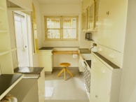 Close-up of beautifully restored kitchen cabinets with a smooth creamy finish.