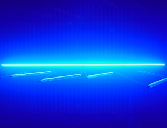 Grid layout of industrial products illuminated by smooth electric blue lighting effects.