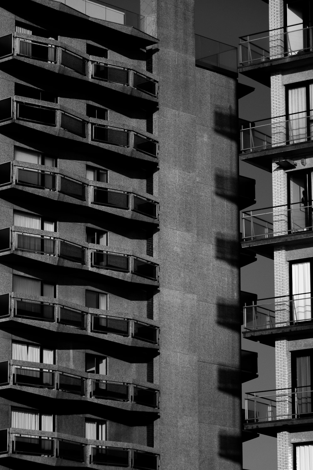 a black and white photo of a building with balconies