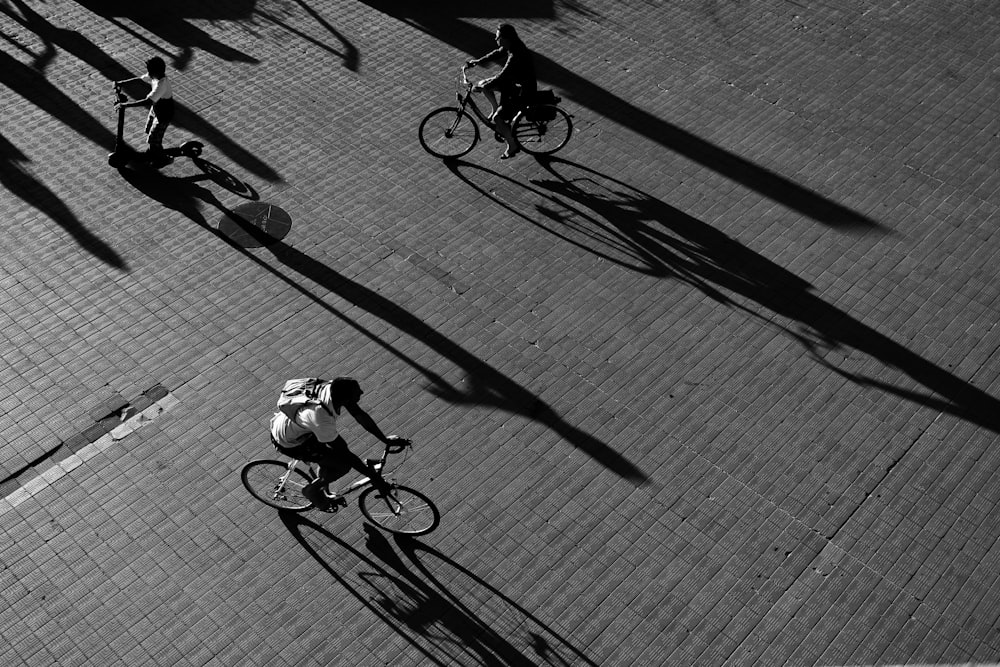 a group of people riding bikes down a street