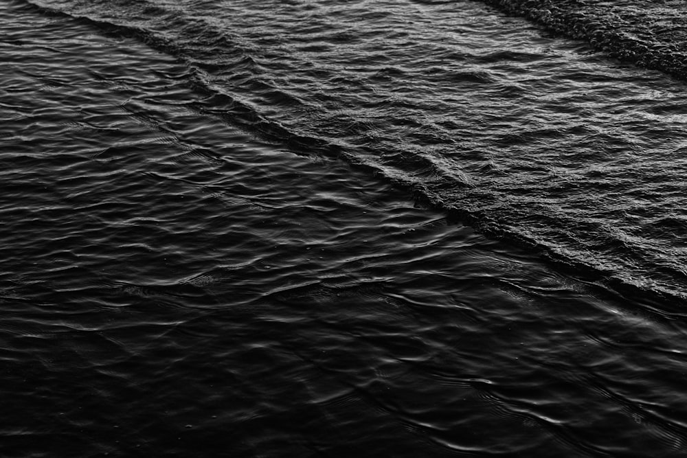 a black and white photo of a boat in the water