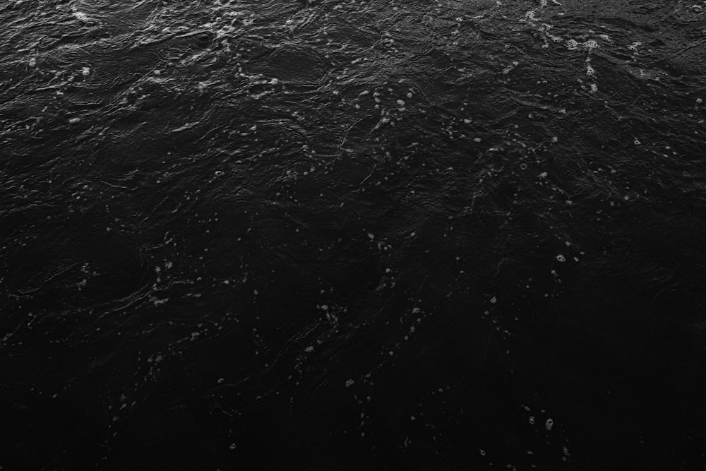 a black and white photo of a boat in the water