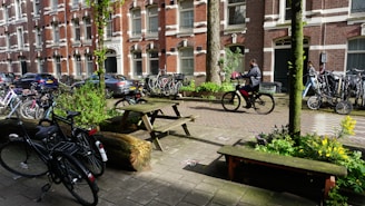 A bustling city street with delivery bikes parked nearby.