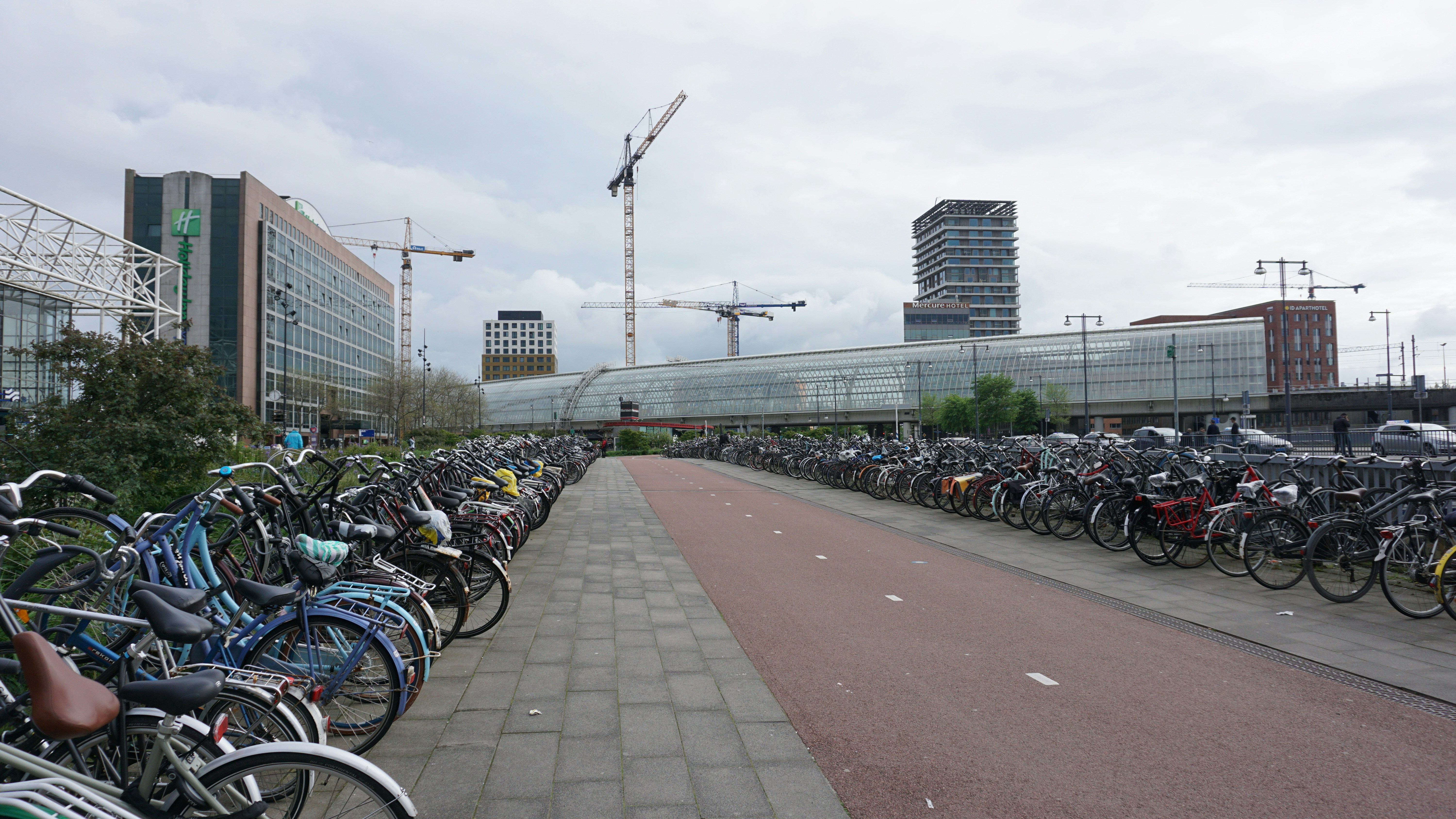 a bunch of bikes are parked on the side of the road