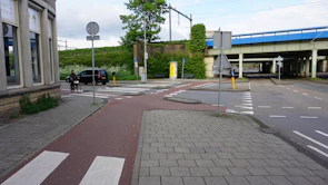 a city street with a car parked on the side of the road