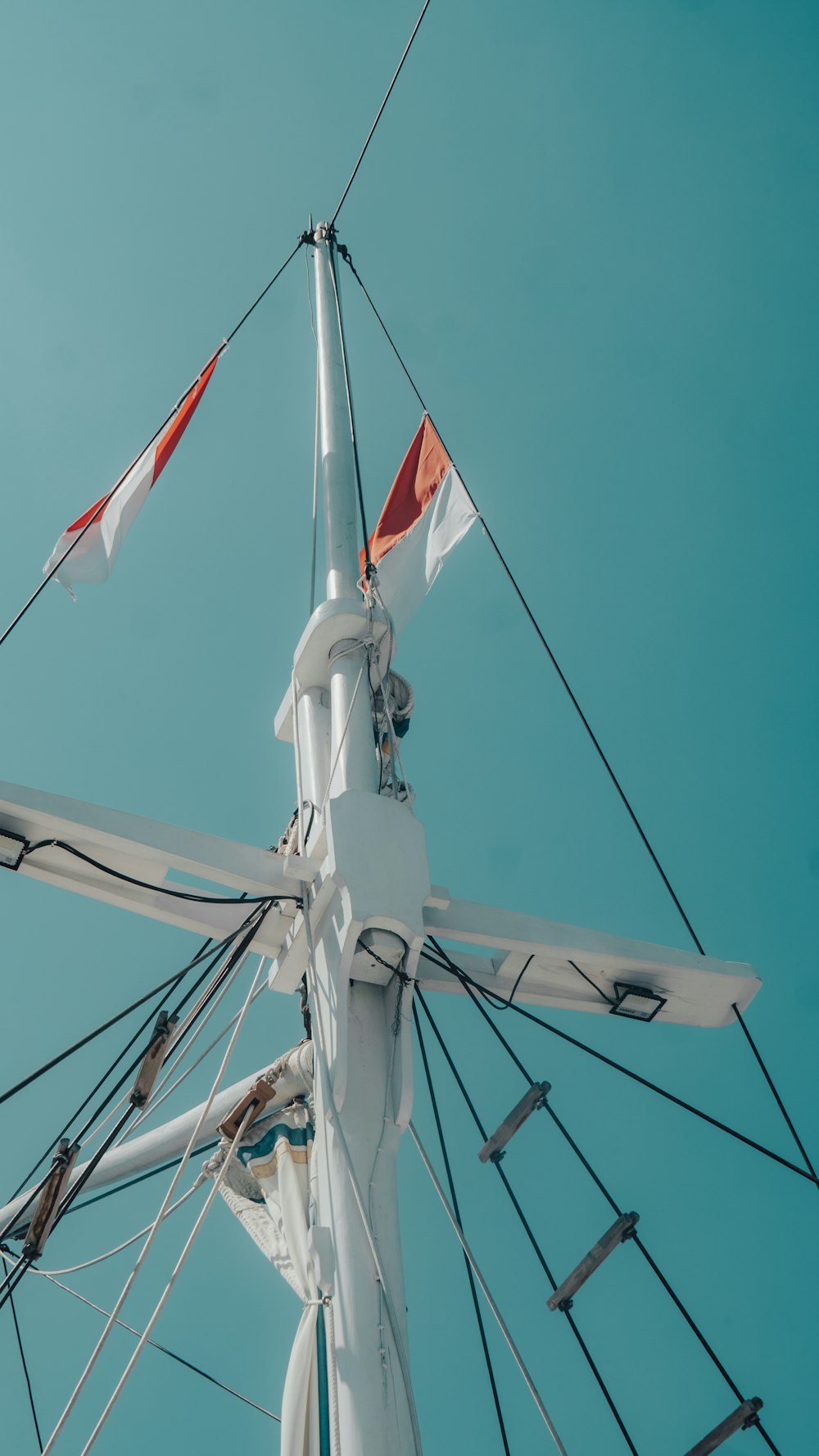 a view of the top of a sail boat mast
