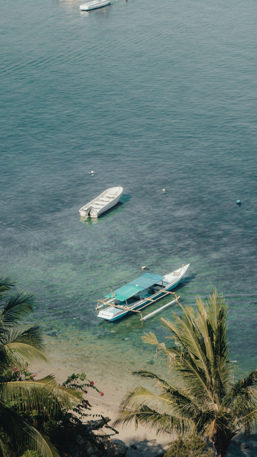 a couple of boats floating on top of a body of water