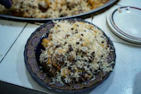 Close-up of a beautifully arranged platter of Kabuli Pulao with vibrant raisins and carrots.
