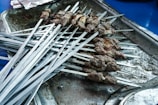 A tray of marinated mutton kebabs arranged neatly for quick cooking.