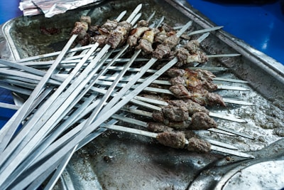 a bunch of skewers that are on a tray