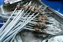 a bunch of skewers that are on a tray