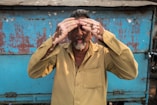 a man covering his eyes with his hands