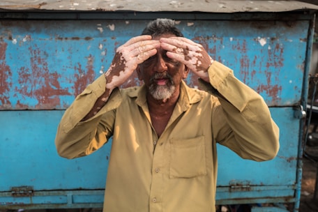 a man covering his eyes with his hands