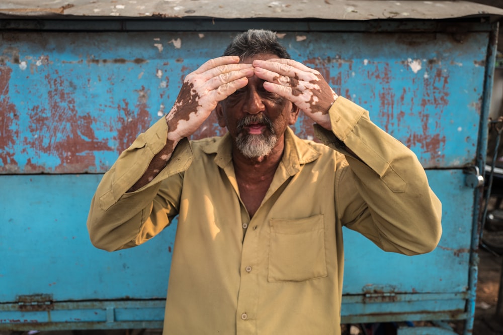 a man covering his eyes with his hands