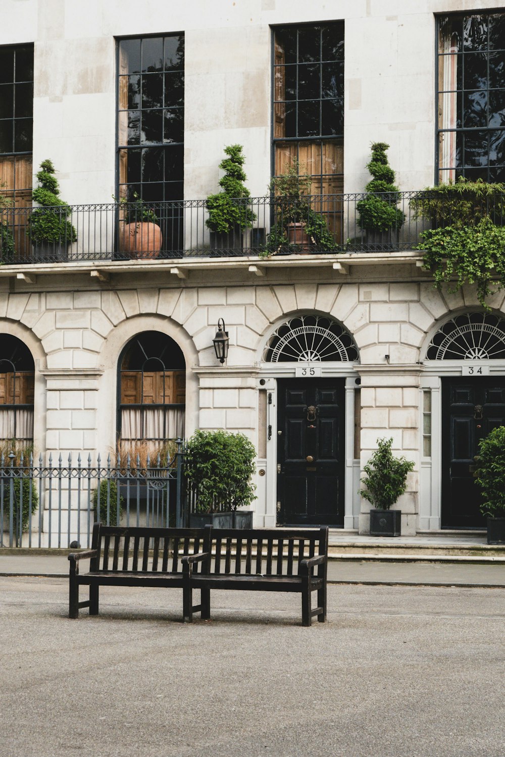 a wooden bench sitting in front of a building