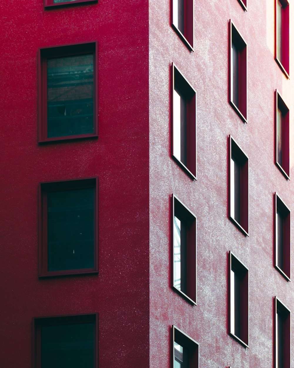 a red building with several windows and a clock
