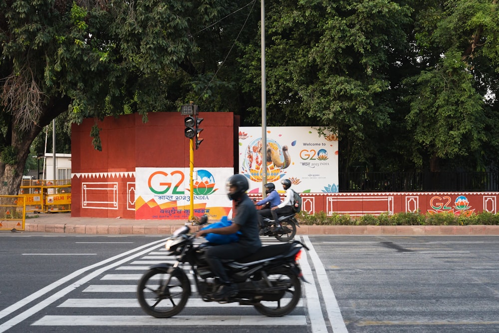 a group of people riding motorcycles down a street