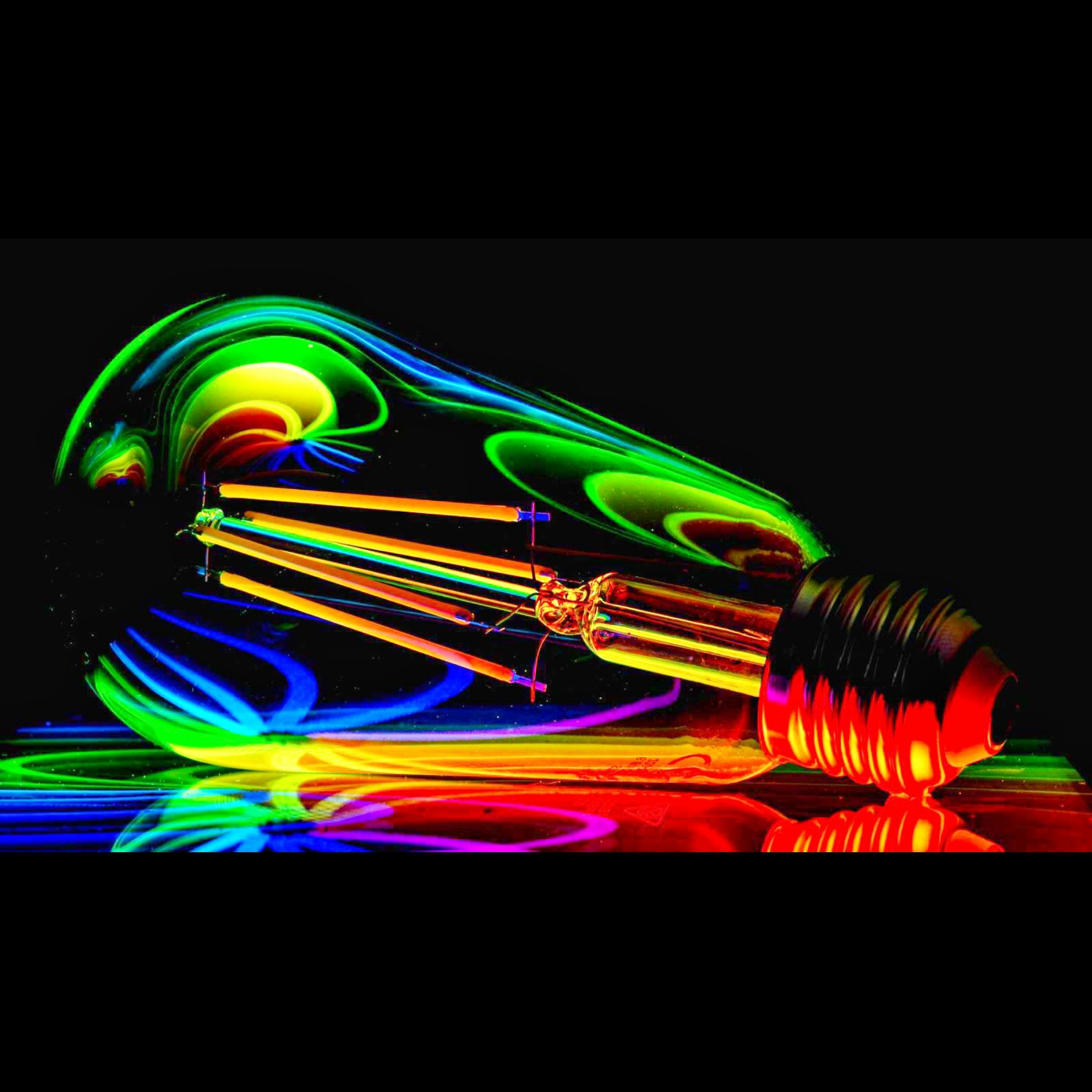 a colorful light bulb sitting on top of a table