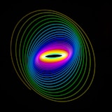 a black background with a multicolored circle in the center