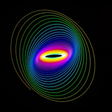 a black background with a multicolored circle in the center