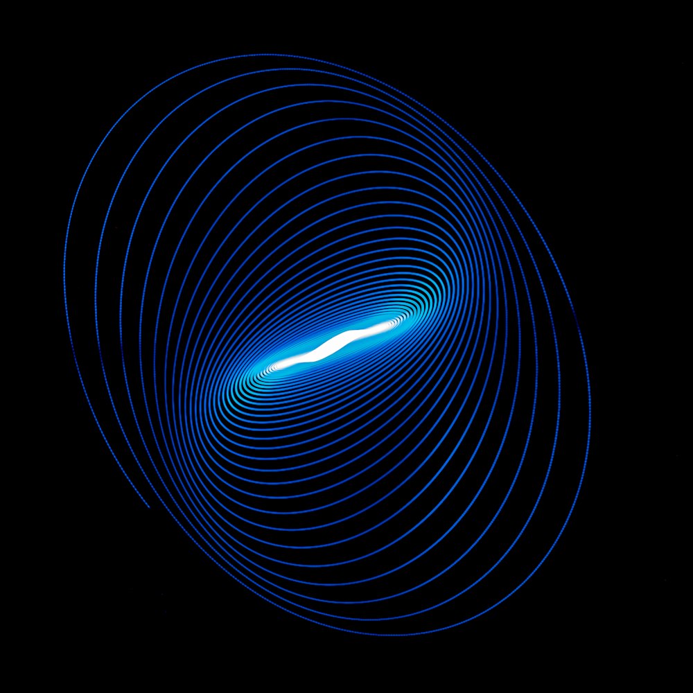 a blue spiral is shown in the dark