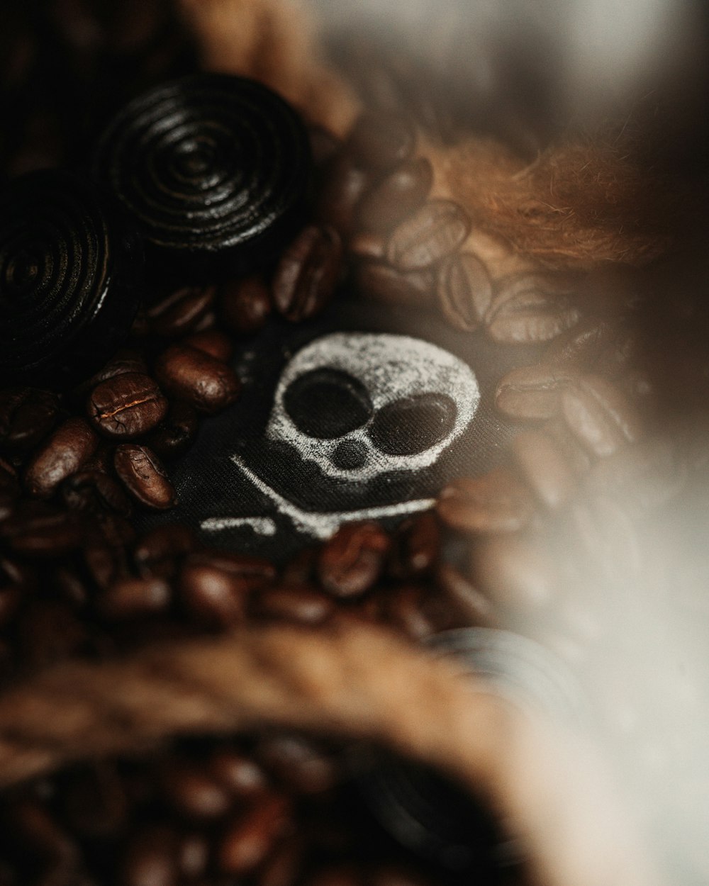 a skull and crossbone on a pile of coffee beans
