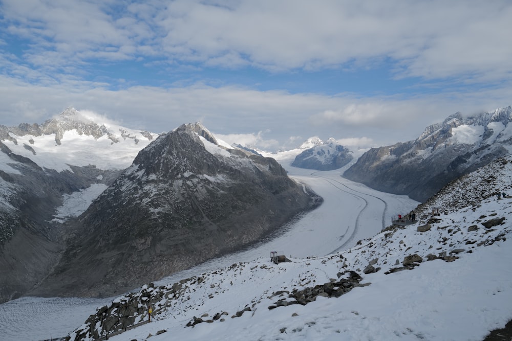 a view of a snowy mountain with a glacier in the distance