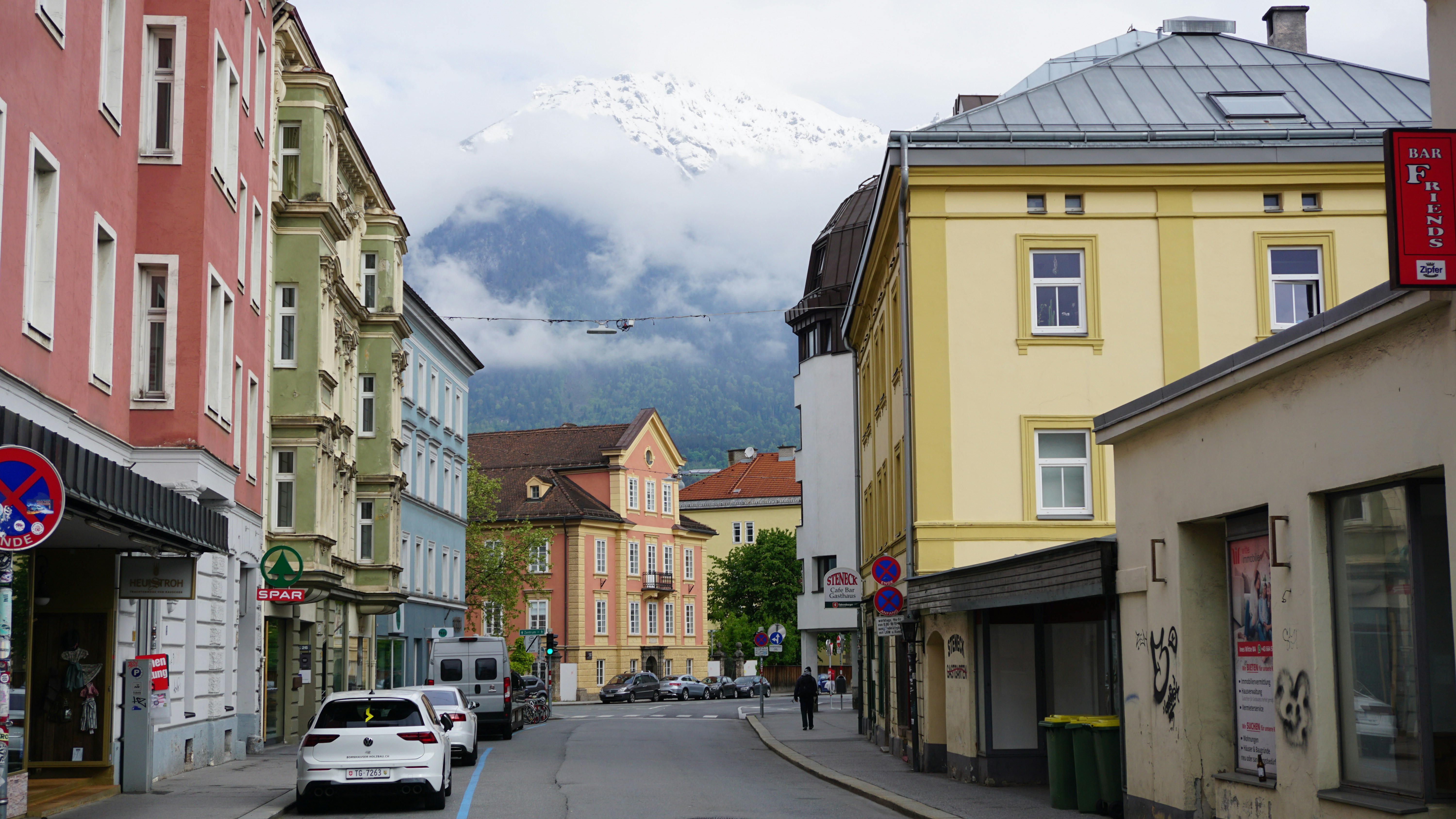 a city street with a mountain in the background