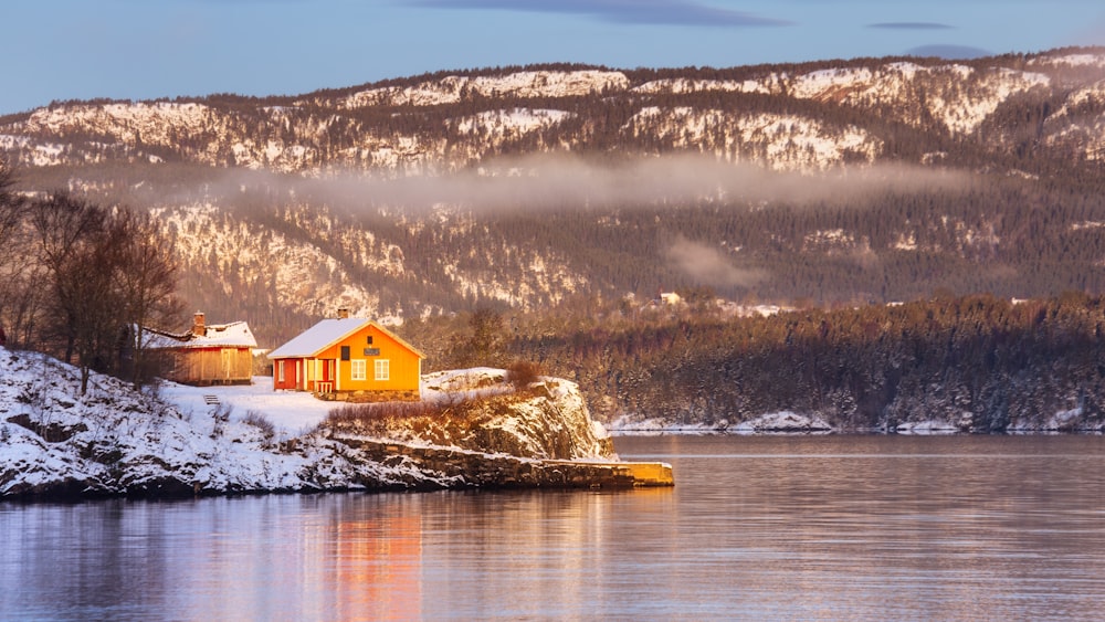 a house on a small island in the middle of a lake