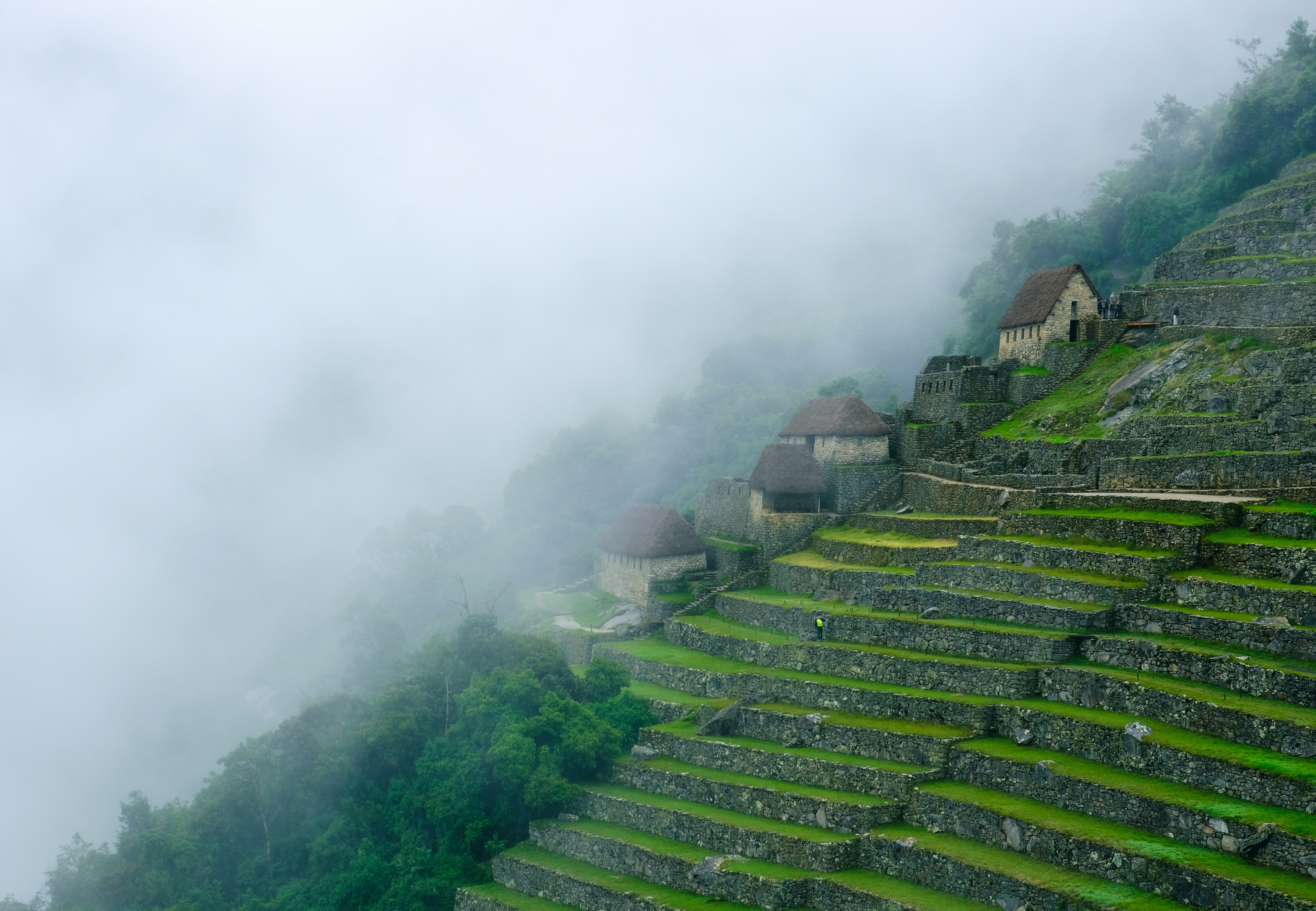 a group of buildings on a mountain side, Machu Picchu, Peru