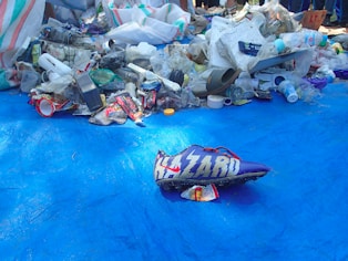 a pile of trash sitting on top of a blue tarp