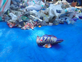 a pile of trash sitting on top of a blue tarp