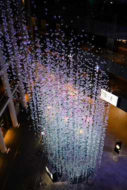 An artistic balloon installation in rich purples and golds, framing a chic event space.