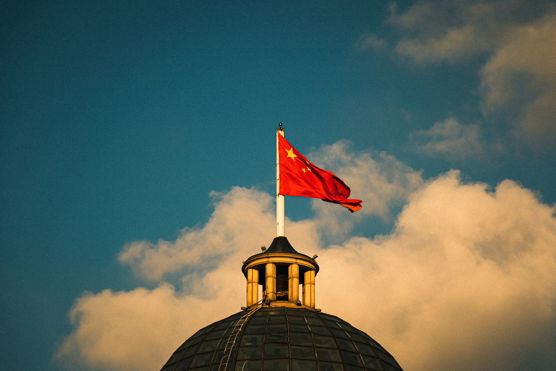 a red and white flag on top of a building
