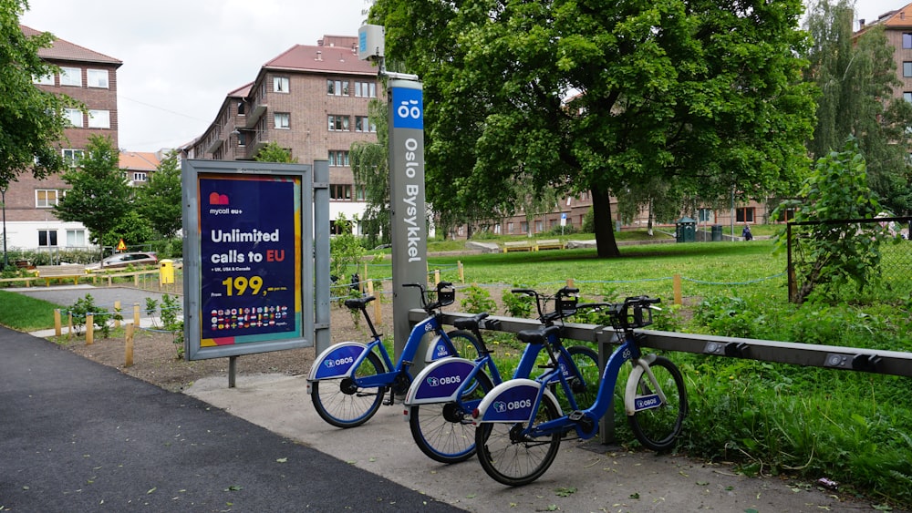 a group of bikes parked next to a street sign