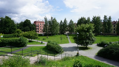 Green park area near the residential complex with walking paths.