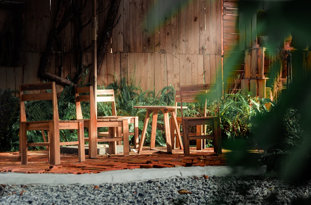 a couple of wooden chairs sitting on top of a wooden deck