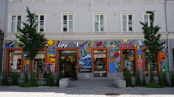 A colorful storefront with large, eye-catching custom graphics wrapping the windows.