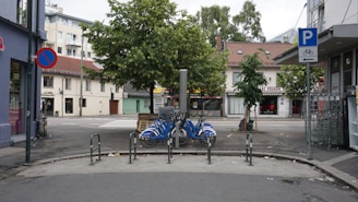 A well-organized bike parking area with various bicycles secured to racks in an urban setting.