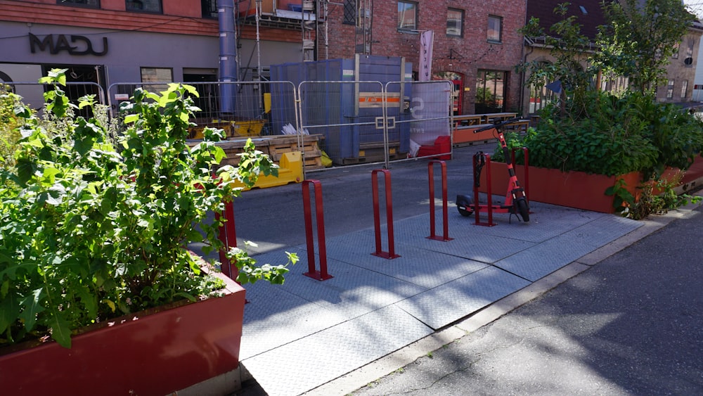 a city street lined with tall red planters