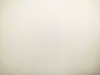 A plain, textured surface with a light beige color, suggesting a minimalistic and clean appearance.