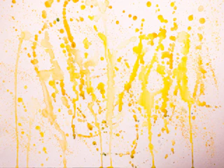 Bright abstract canvas with splashes of yellow and green.