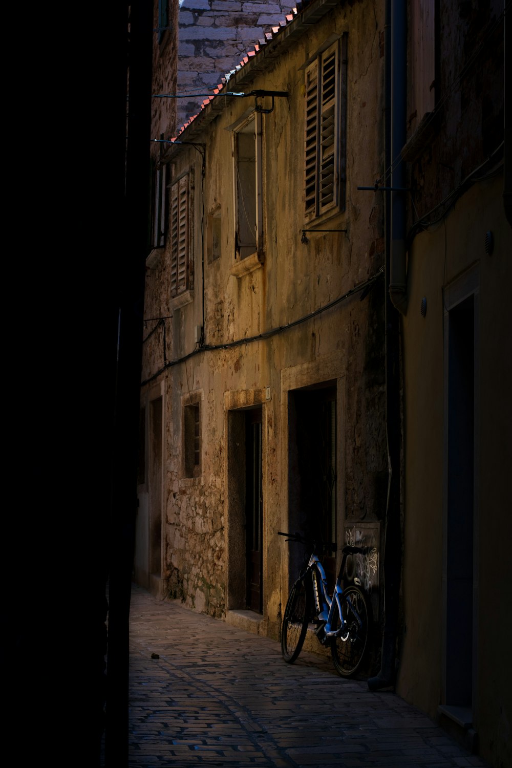 a bike parked on the side of a building