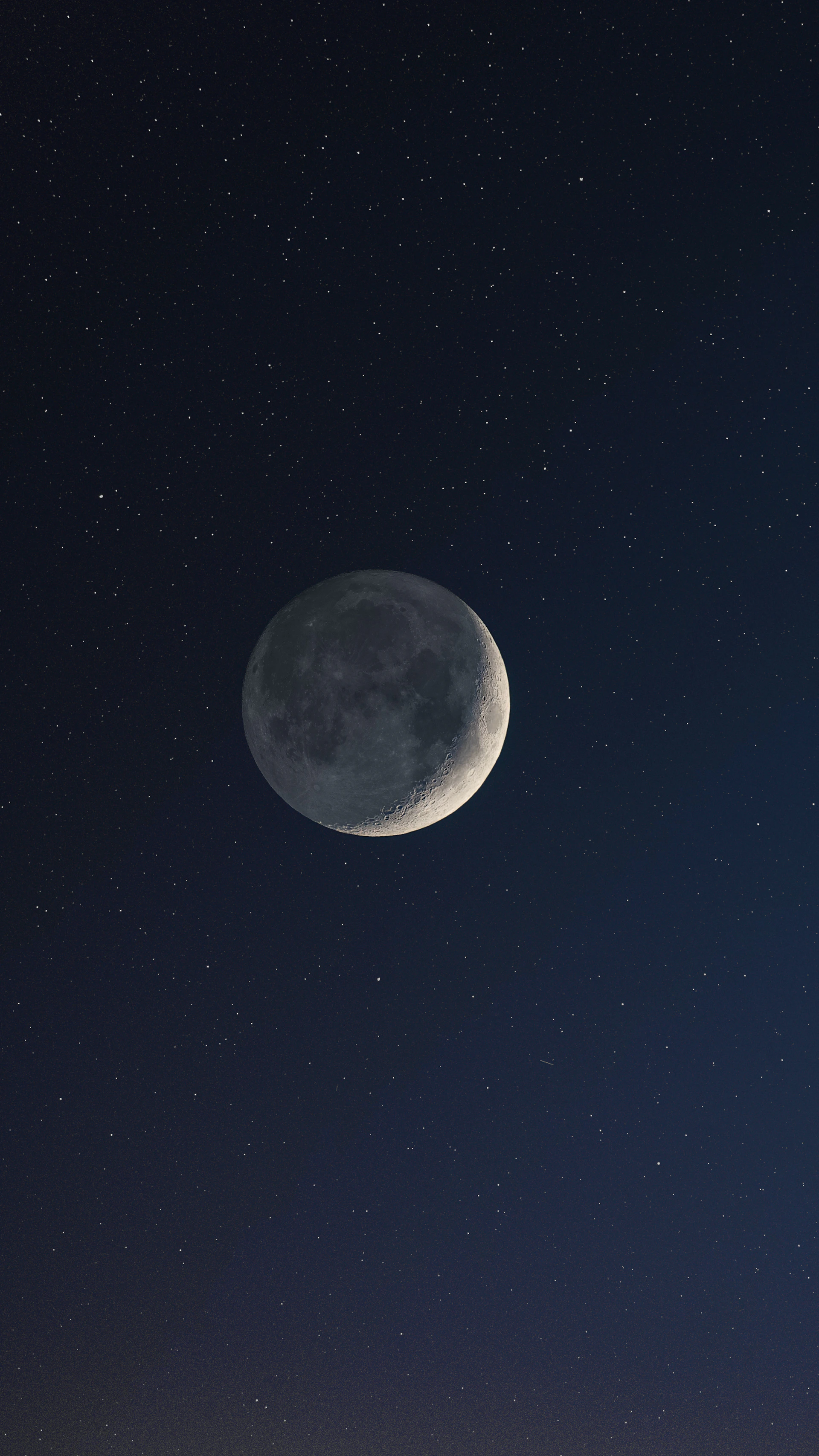 a full moon is seen in the night sky