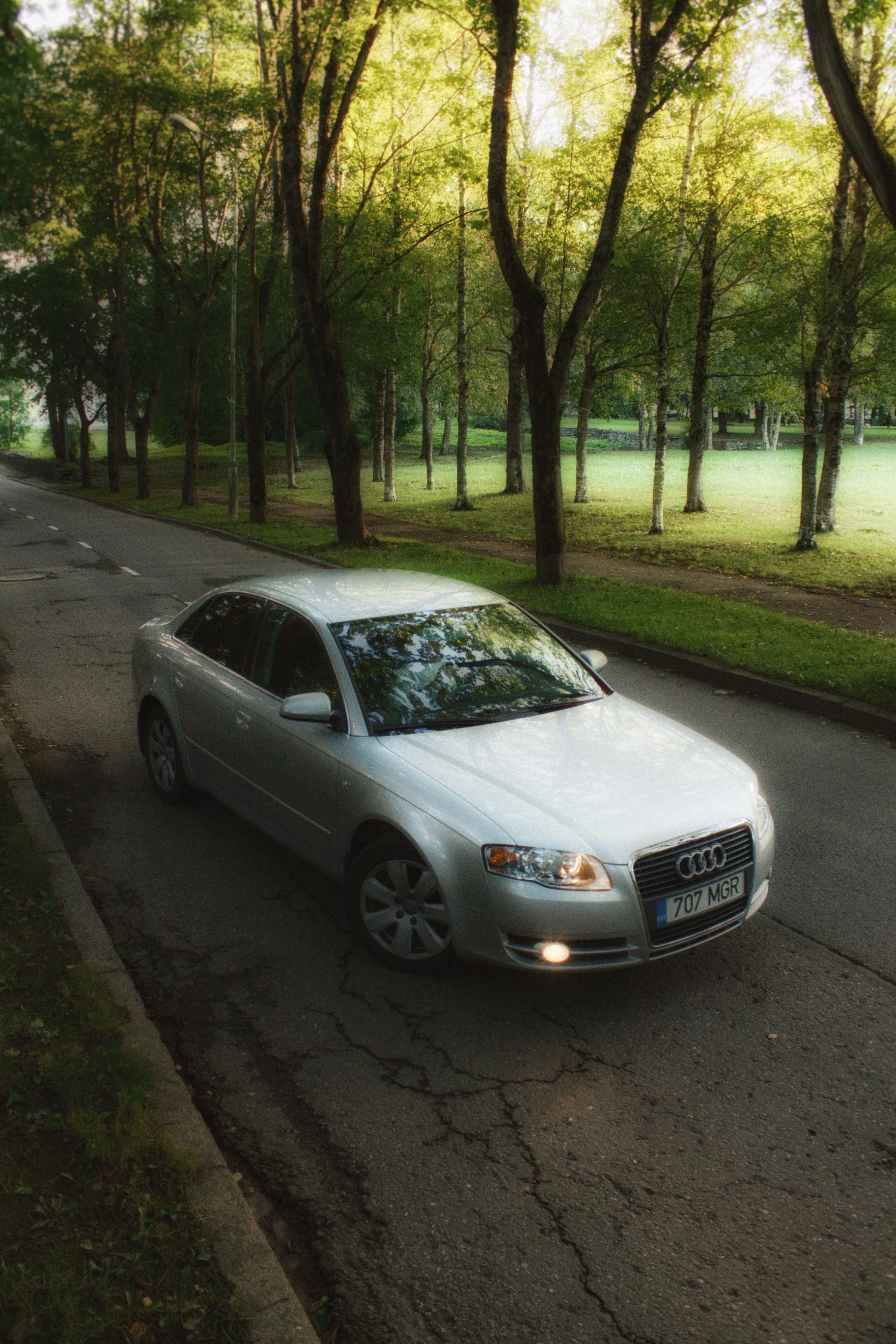 a silver car parked on the side of the road