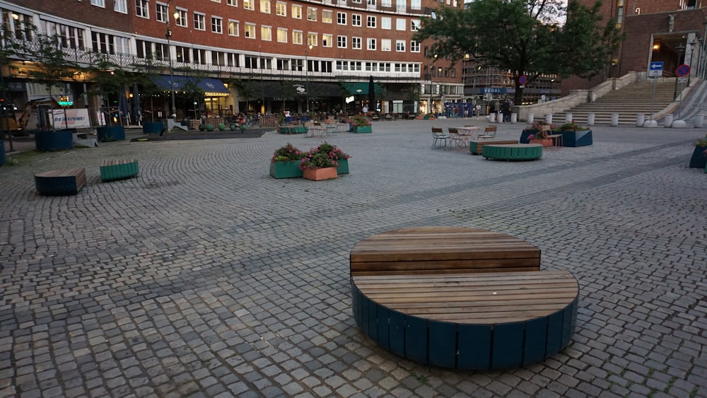 a large courtyard with benches and tables in the middle of it