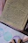 A warm close-up of a handwritten letter resting on textured cream paper with a gentle shadow.