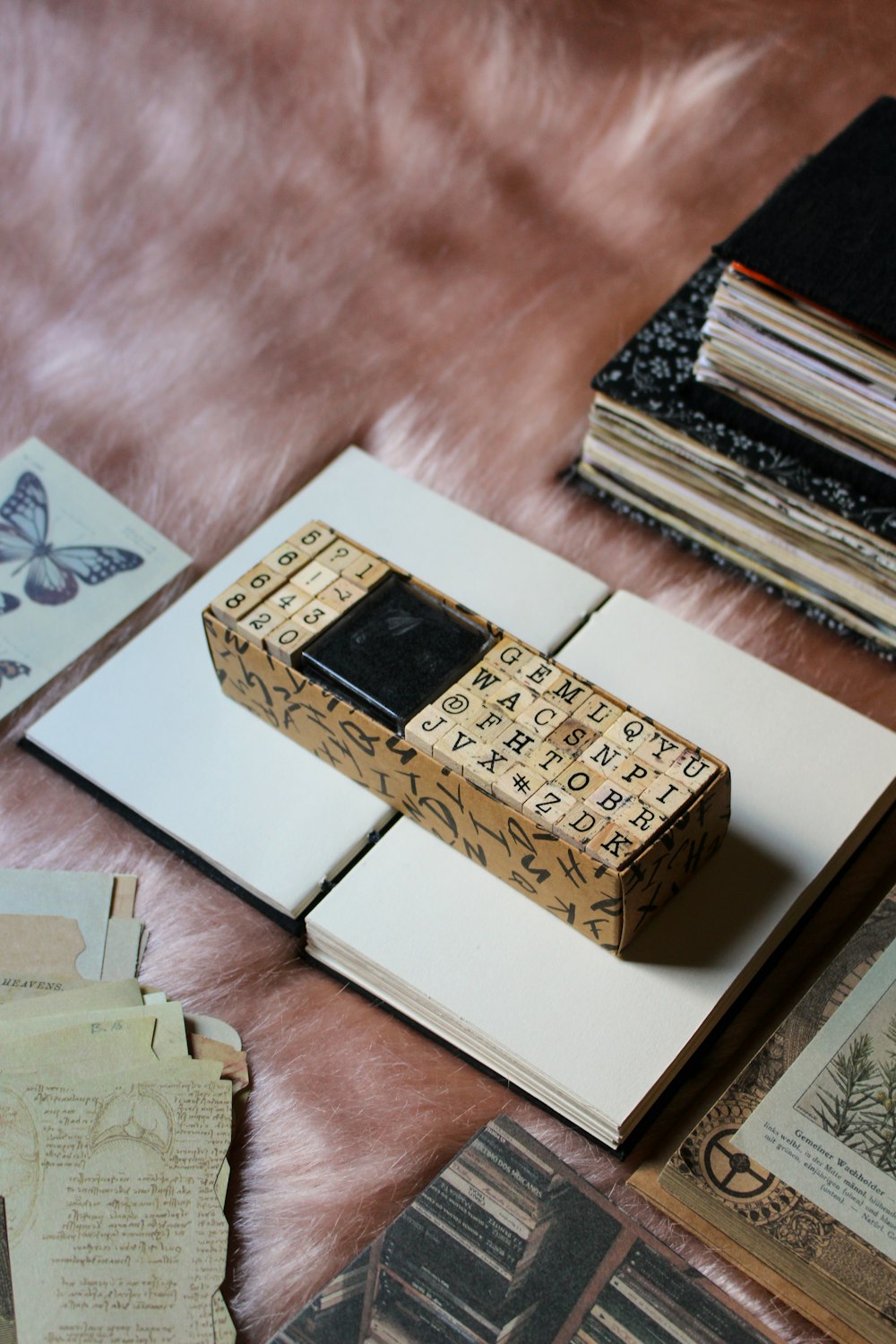 a wooden box sitting on top of a pile of books