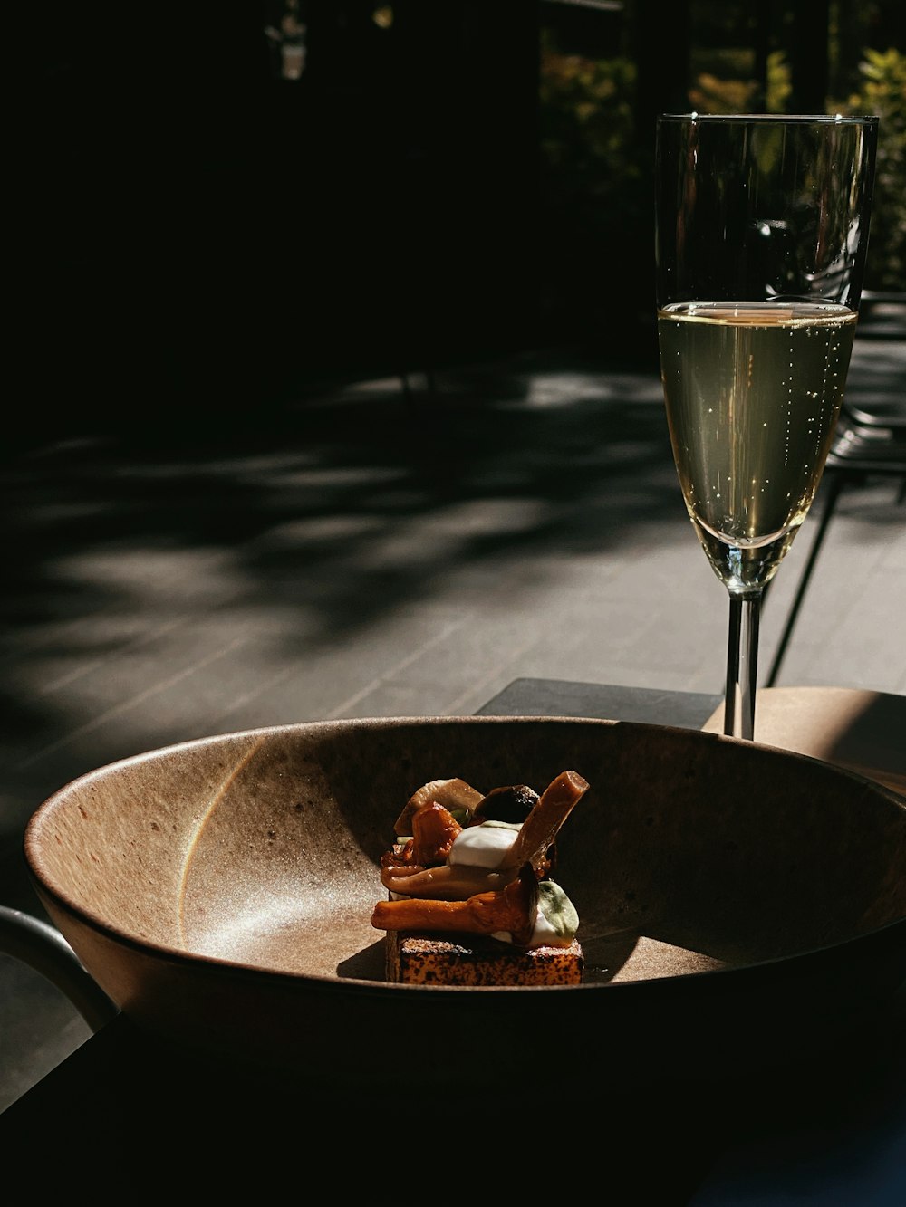 a glass of wine sitting on top of a table